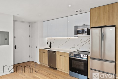 A kitchen with wooden cabinets and a black oven.