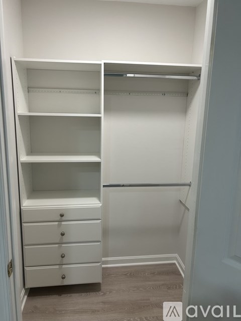 A white closet with drawers and shelves.