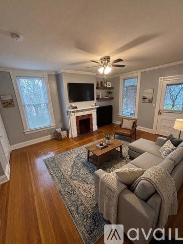 A living room with a grey couch and a wooden coffee table.