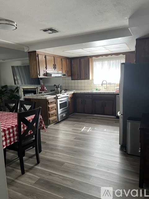 A kitchen with a table and chairs in it.