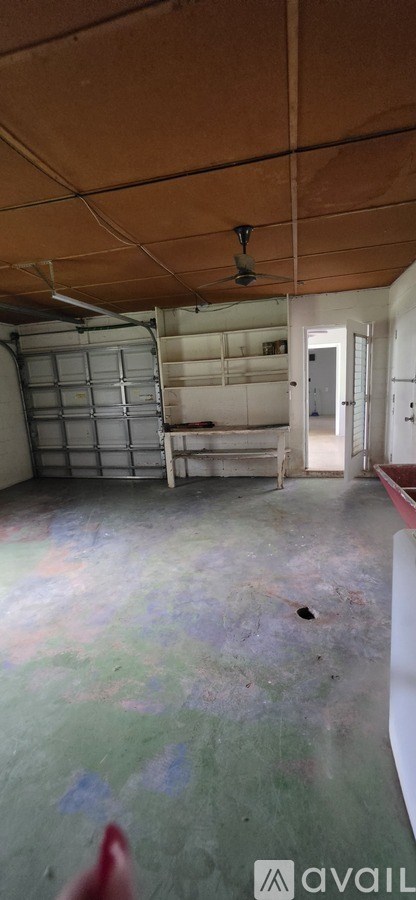 A room with a brown ceiling and a white door.
