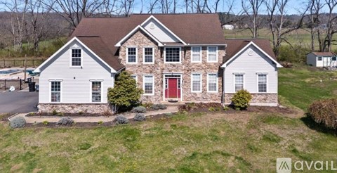 A house with a red door is for sale.