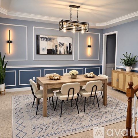 A dining room with a wooden table and chairs.