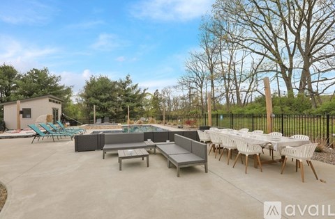 A pool area with a table and chairs is available for use.