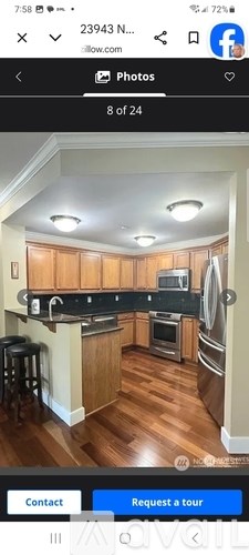 A kitchen with wooden cabinets and a black countertop.