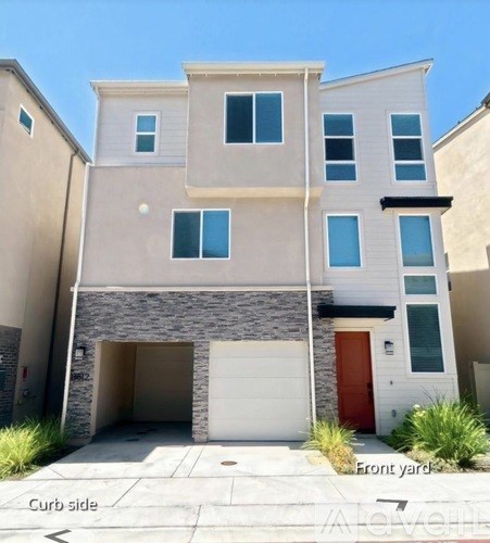 A two-story house with a front yard and a curb side.