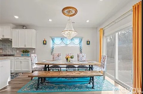 A dining room with a table set for four.