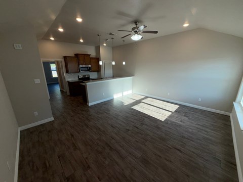 A room with wooden flooring and a ceiling fan.