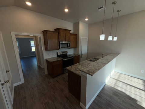 A kitchen with a counter top and cabinets.
