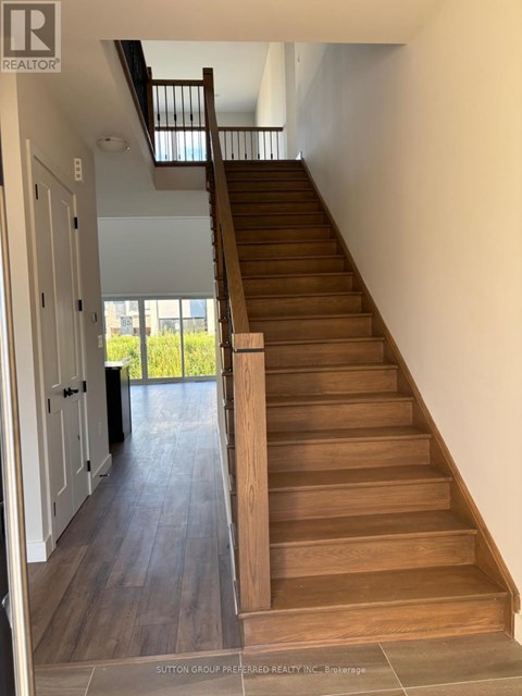 A wooden staircase with a skylight above it.