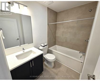 A bathroom with a sink, toilet, and bathtub.