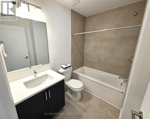 A bathroom with a sink, toilet, and bathtub.