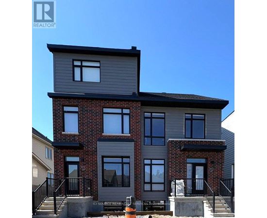 A modern two-story house with a brick facade and grey siding.
