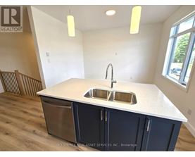 A kitchen with a sink and a window.