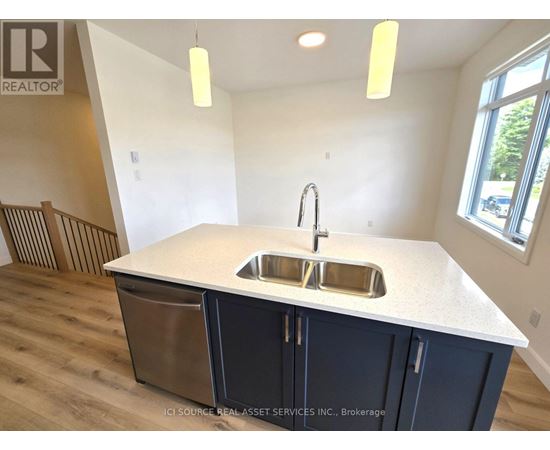 A kitchen with a sink and a window.