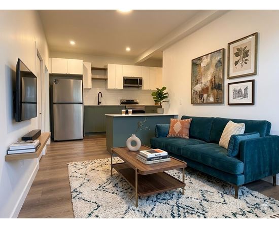 A living room with a blue couch and a coffee table.