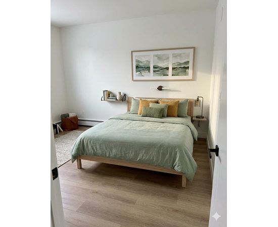 A bedroom with a bed, nightstands, and a painting on the wall.