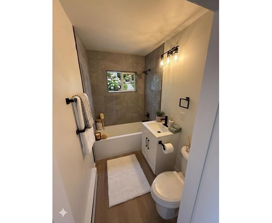 A bathroom with a white toilet, a white sink, and a white bathtub.