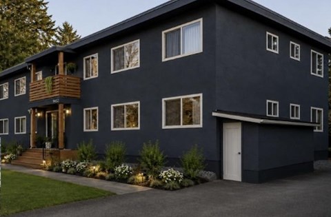 A modern house with a balcony and a white door.