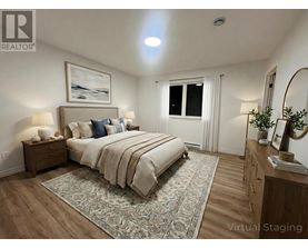 A bedroom with a large bed, a nightstand, and a dresser.