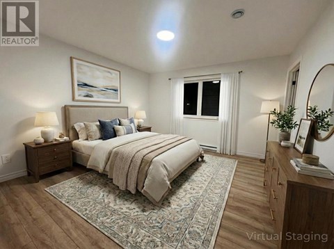 A bedroom with a large bed, a nightstand, and a dresser.