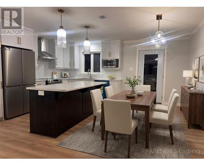 A modern kitchen with a dining table and chairs.