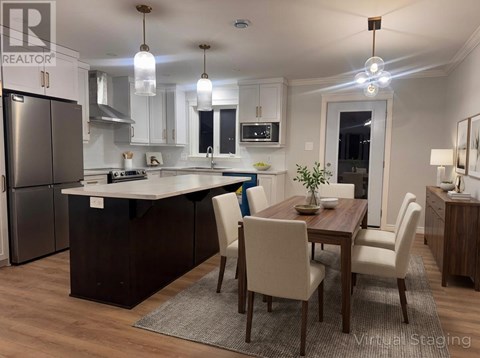 A modern kitchen with a dining table and chairs.
