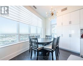 A dining room with a table set for four.