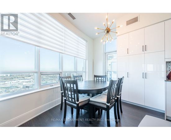 A dining room with a table set for four.