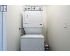 A white oven and stove top are installed in a small kitchen.