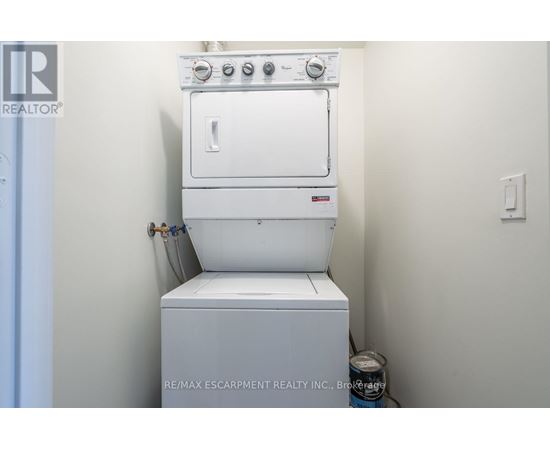 A white oven and stove top are installed in a small kitchen.