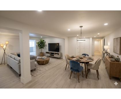 A modern living room with a dining area and a television.
