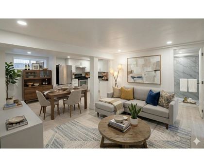 A modern living room with a dining table and a sofa.