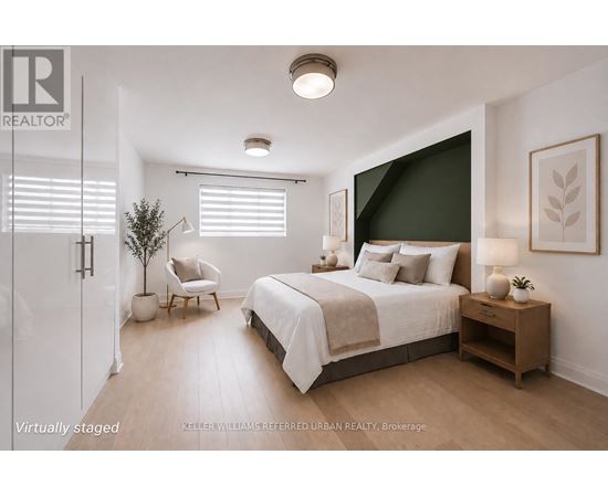 A bedroom with a bed, chair, and nightstand.