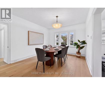 A dining room with a table and chairs.