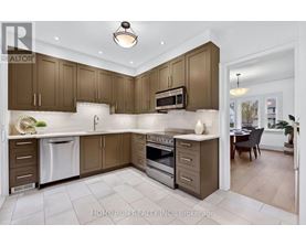 A modern kitchen with brown cabinets and a white dishwasher.