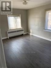 A room with a window and a radiator on the wall.