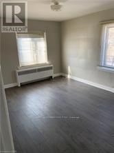 A room with a window and a radiator on the wall.