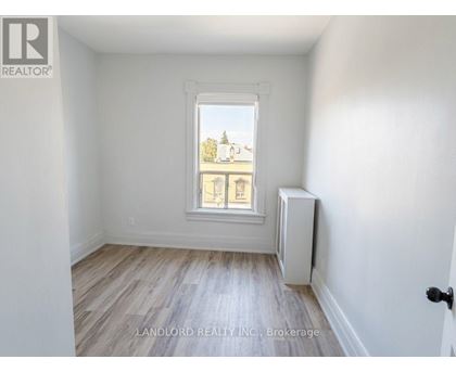 A room with a window and a radiator on the wall.