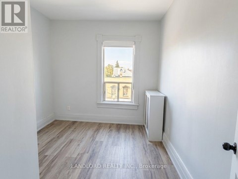 A room with a window and a radiator on the wall.