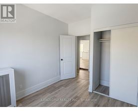 A room with a white door and a white cabinet.