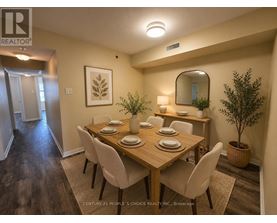 A dining room with a wooden table and chairs.