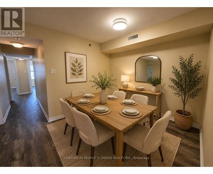 A dining room with a wooden table and chairs.
