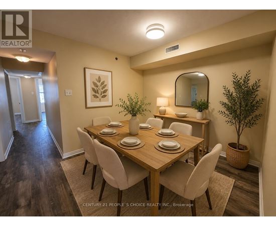 A dining room with a wooden table and chairs.