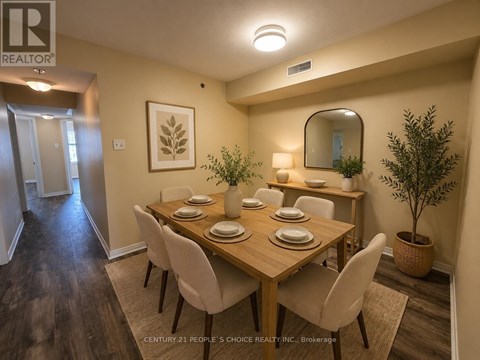 A dining room with a wooden table and chairs.