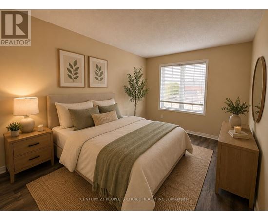 A bedroom with a bed, nightstands, and a plant.