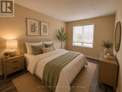 A bedroom with a bed, nightstands, and a plant.