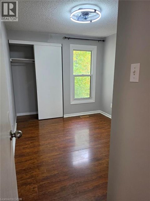 A room with a door leading to a backyard.
