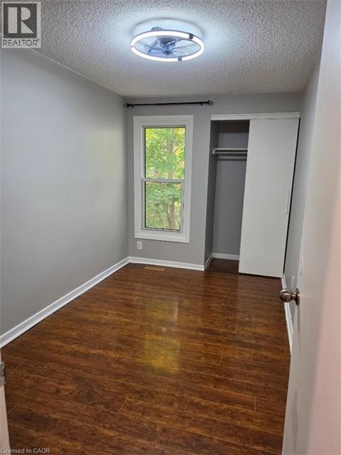 A room with a wooden floor and a window.