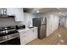 A kitchen with white cabinets and stainless steel appliances.